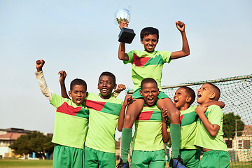 Image showing The trophy is ours. Portrait of a boys soccer team celebrating their victory on a sports field.