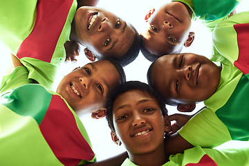 Image showing When we play as a team, we rise as champions. Portrait of a boys soccer team standing together in a huddle.