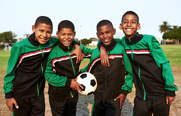 Image showing Soccer teaches kids skills such as teamwork and perseverance. Portrait of a boys soccer team standing together on a sports field.