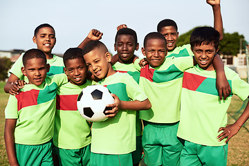 Image showing Dream, believe, achieve. Portrait of a boys soccer team standing together on a sports field.