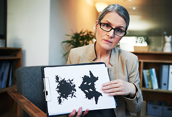 Image showing What do you see when you look at this picture. Portrait of a mature psychologist holding up an inkblot test during a therapeutic session.
