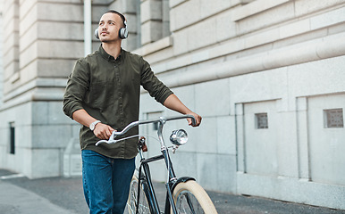 Image showing Success comes to those who seek it. a young businessman riding a bicycle in the city.