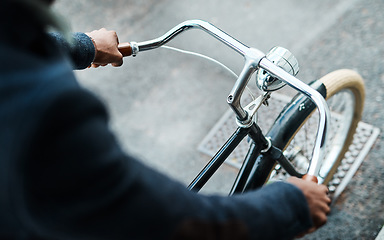 Image showing Get a grip on your goals. an unrecognisable businessman riding a bicycle through the city.