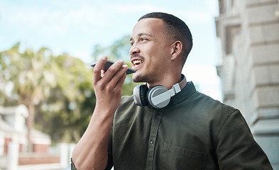 Image showing The guy everyone wants to connect with. a young businessman using a smartphone against an urban background.