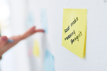 Image showing Taking note of the big plan. Closeup shot of an unrecognisable businesswoman brainstorming with notes on a wall in an office.