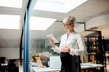 Image showing Managing your pregnancy while working can be quite the juggling act. a pregnant businesswoman using a digital tablet in an office.