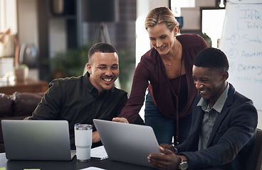 Image showing Perfecting the little touches to their big plan. a group of businesspeople working together on a laptop in an office.