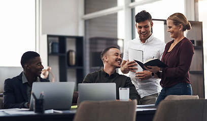 Image showing Theyre a team who diligently and cooperatively work together. a group of businesspeople having a discussion in an office.