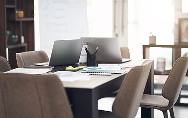 Image showing Success is created in this space. Still life shot of laptops and paperwork on a table in a modern office.