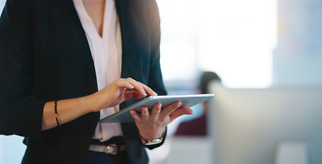 Image showing Doing research off the record. an unrecognizable businesswoman browsing on her digital tablet inside of the office during the day.