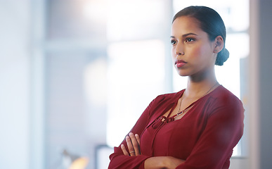 Image showing Making sure everyone is doing their work. a confident young businesswoman standing with her arms folded inside of the office.