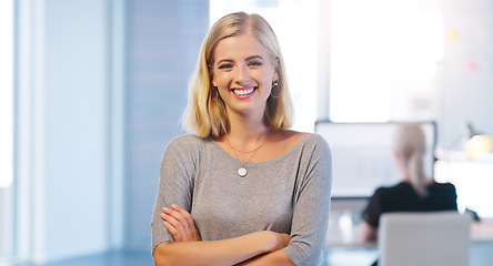 Image showing Everything is running smoothly today. Portrait of a confident young businesswoman standing with her arms folded inside of the office.