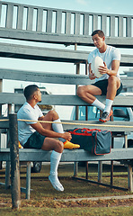 Image showing Sharing some helpful tips. two rugby players having a conversation while sitting on a bench.