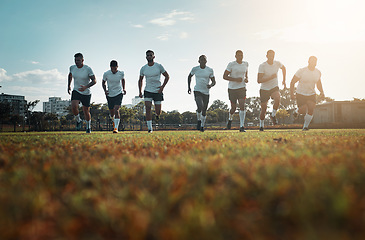 Image showing Come with confidence and leave as champions. Rearview shot of a group of young rugby players running on a field.
