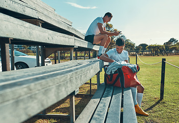 Image showing He always come to practice with a positive attitude. two rugby players sitting on a bench.