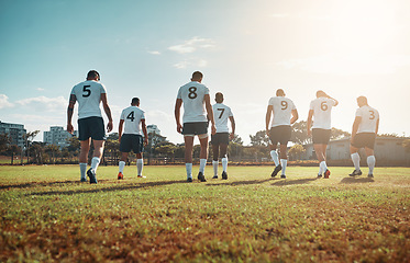 Image showing Theyre champions whether they win or lose. Rearview shot of a group of young rugby players walking on a field.