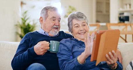 Image showing Tablet, coffee and a senior couple in their home to relax together during retirement for happy bonding. Technology, smile or love with an elderly man and woman drinking tea in their living room