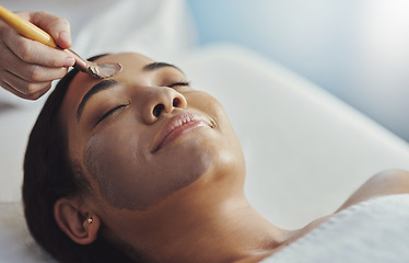 Image showing Let the professionals help you get that glow. a young woman getting a facial treatment at a spa.