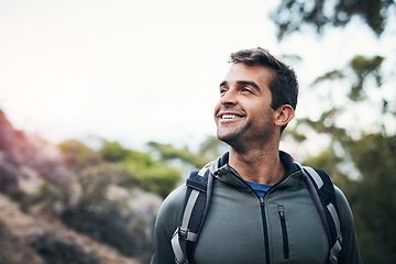 Image showing What a beautiful day for a hike. a cheerful young man looking into the distance while going for a hike up a mountain.