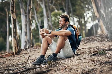 Image showing Wish you could have joined me. a carefree young man taking a quick break from hiking up a mountain during the day.