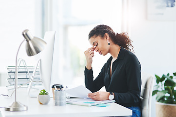 Image showing Beware the chair - excessive sitting can lead to tension headaches. a young businesswoman looking stressed out while working in an office.