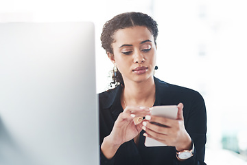 Image showing Handling business like the pro she is. a young businesswoman using a cellphone while working in an office.