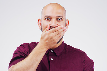 Image showing I dont know if I can tell you...Studio shot of a young man looking shocked against a grey background.