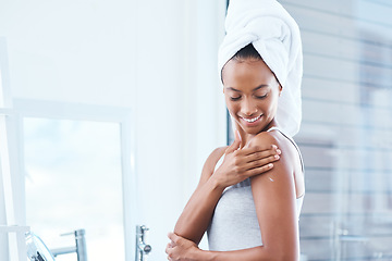 Image showing Take care of the skin youre in. a young woman applying moisturizer to her body.