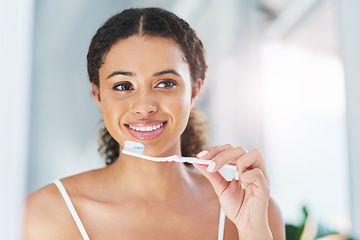 Image showing Fresh breath is how you start your day. an attractive young woman brushing her teeth in the bathroom at home.