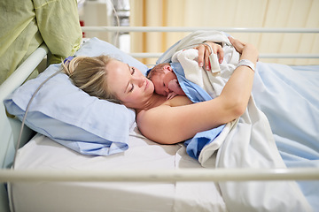 Image showing Ill cherish this moment forever. a beautiful young mother lying in bed with her newly born baby girl in the hospital.