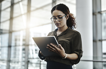 Image showing The goal is to work efficiently. an attractive young businesswoman using a digital tablet in a modern office.