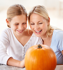 Image showing Halloween fun. a mother and daughter carving a pumpkin together.
