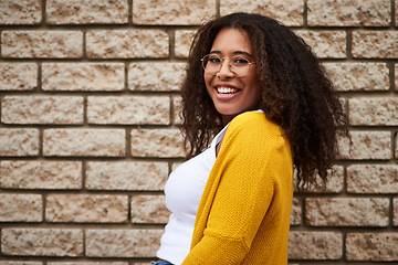 Image showing Happiness lives in me. Cropped portrait of a happy young woman posing against a brick wall.