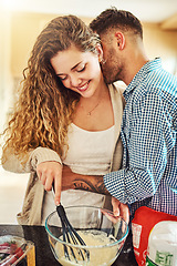 Image showing We love making things in the kitchen. a loving couple baking in their kitchen.