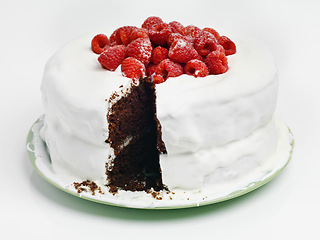 Image showing When in doubt choose chocaolate. Studio shot of a delicious chocolate cake with frosting and raspberries.