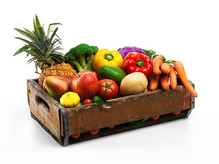 Image showing Overflowing with natures bounty. Studio shot of a box full of fresh vegetables and fruit against a white background.