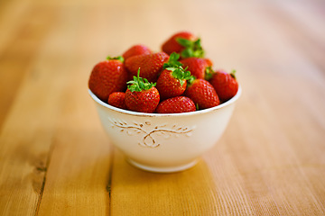 Image showing Not just for jam. a bowl of strawberries on a wooden table.