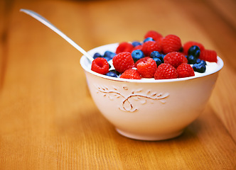 Image showing Starting the day well. a delicious bowl of berries and yoghurt.