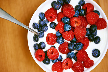 Image showing Have a bowl of goodness. High angle shot of a delicious bowl of berries and yoghurt.