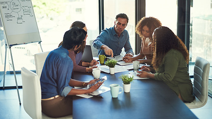 Image showing Making plans to stay ahead of business. a group of businesspeople having a meeting in an office.