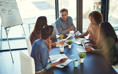 Image showing Id like you to lead the task. a group of businesspeople having a meeting in an office.