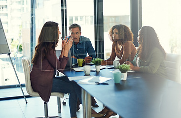 Image showing Laying out all their ideas on the table. a group of businesspeople having a meeting in an office.