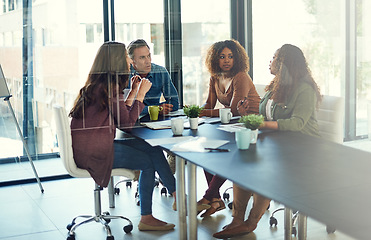 Image showing Pushing themselves towards greatness. a group of businesspeople having a meeting in an office.