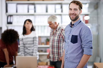 Image showing This business is the perfect fit for me. Portrait of a handsome young businessman with his colleagues working in the background.