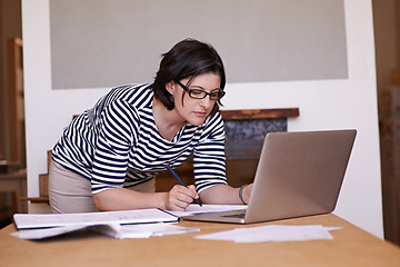 Image showing Dreams dont work unless you do. A cropped shot of a woman standing at her desk and working on her laptop.