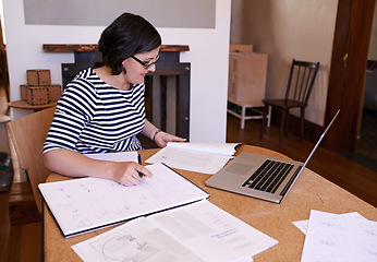 Image showing Designer at work. A cropped shot of a woman doing paperwork in her home office.