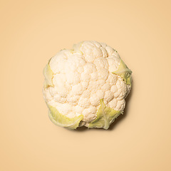 Image showing White sauce makes this outstanding. a head of cauliflower against an empty studio background.