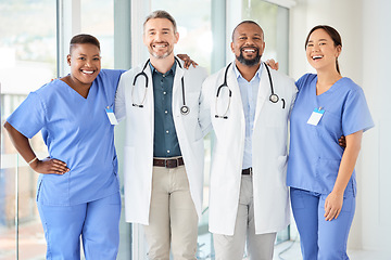 Image showing Never fear, the doctors are here. a cheerful group of doctors standing with their arms around each other inside of a hospital during the day.