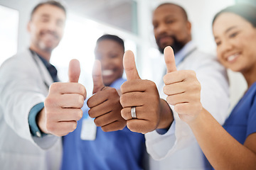 Image showing Your health and safety is important to them. a group of doctors showing a thumbs up in a office.