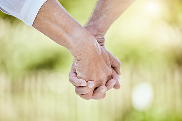 Image showing The only thing worth holding on to is each other. a senior couple holding hands while spending time outdoors.